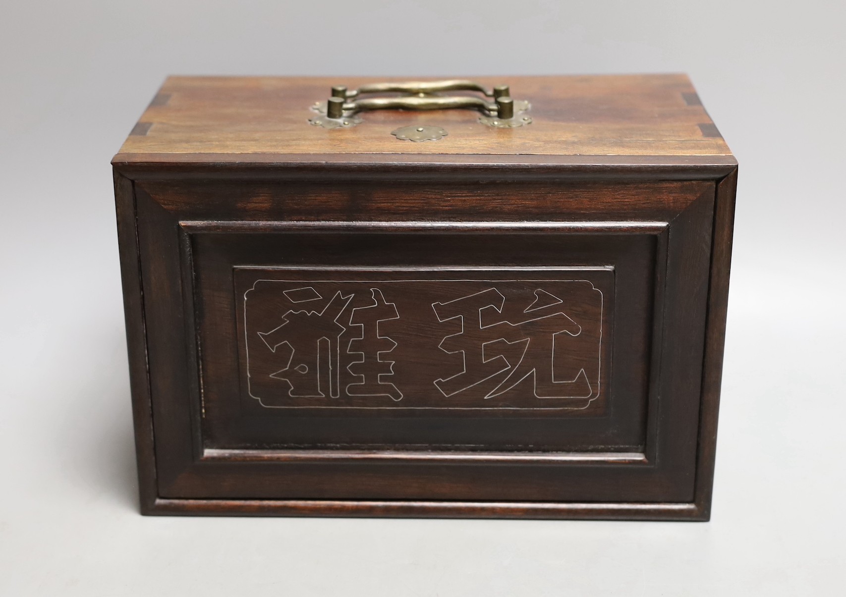 A Chinese boxed mahjong set, bone and bamboo gaming pieces, 24.5 cms wide x 16cms high.